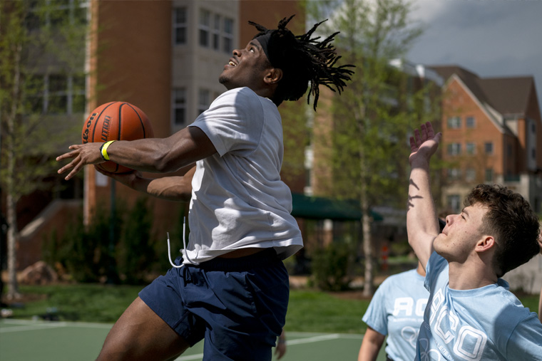 Students compete in basketball at the annual Residential College Olympics