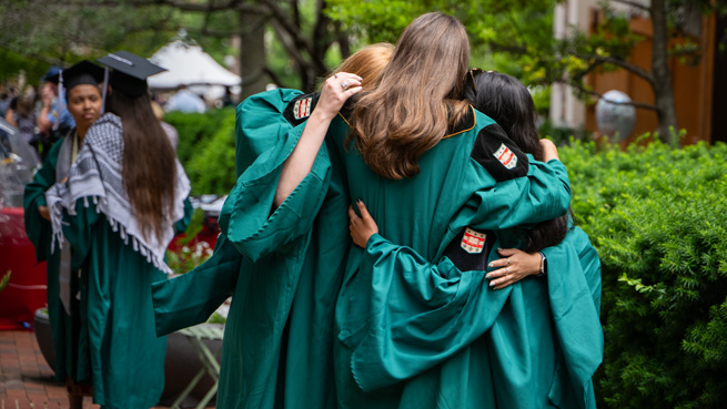 Students hugging at graduation