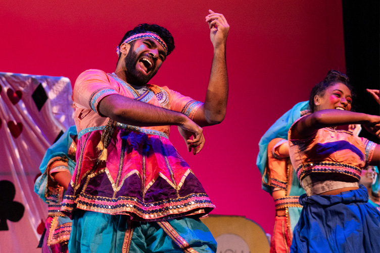 Performers on stage dancing