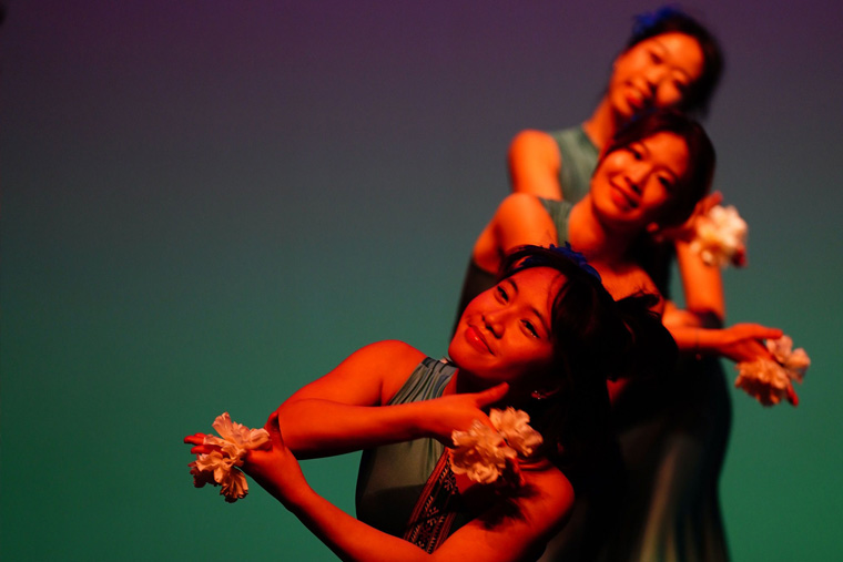 Three students on stage performing during Lunar New Year event