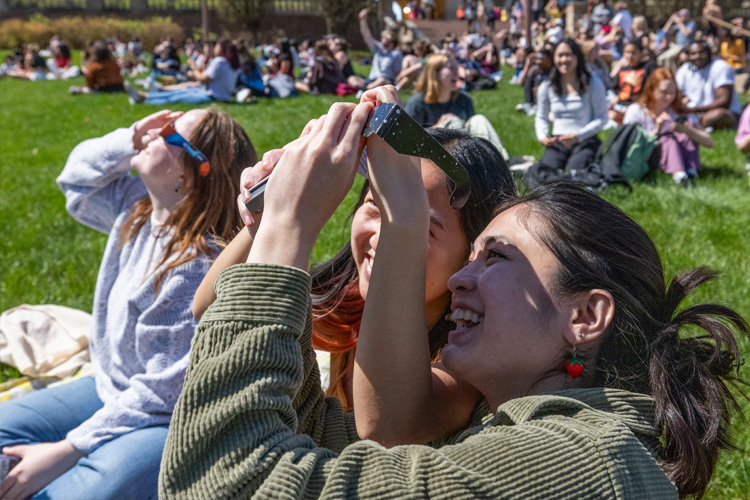 Students viewing solar eclipse on the Brookings Hall steps