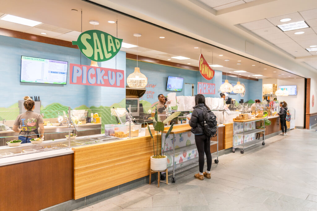 Collins Farms ordering counter. A student places an order with an employee behind the counter.