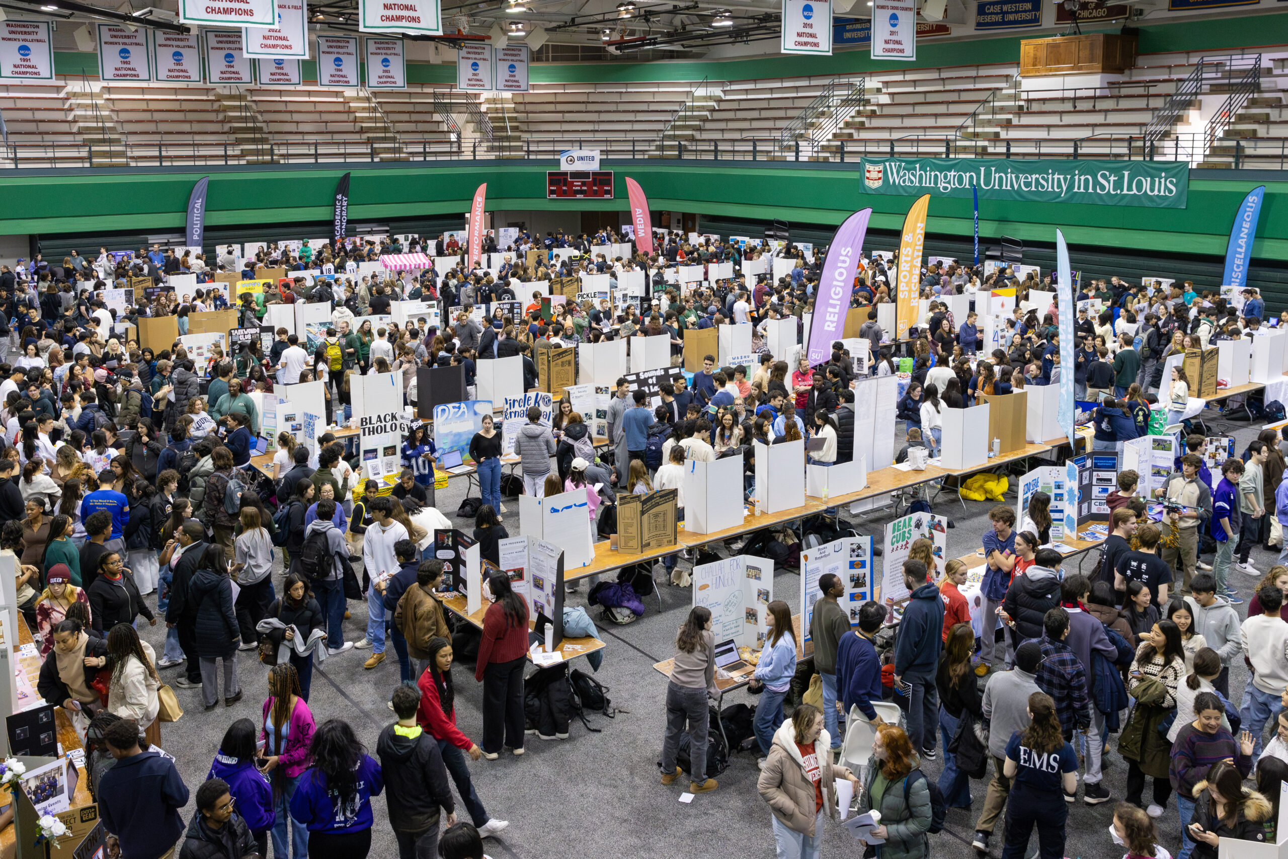 An overhead view of the Activities Fair showing rows of tables with displays and a large crowd.