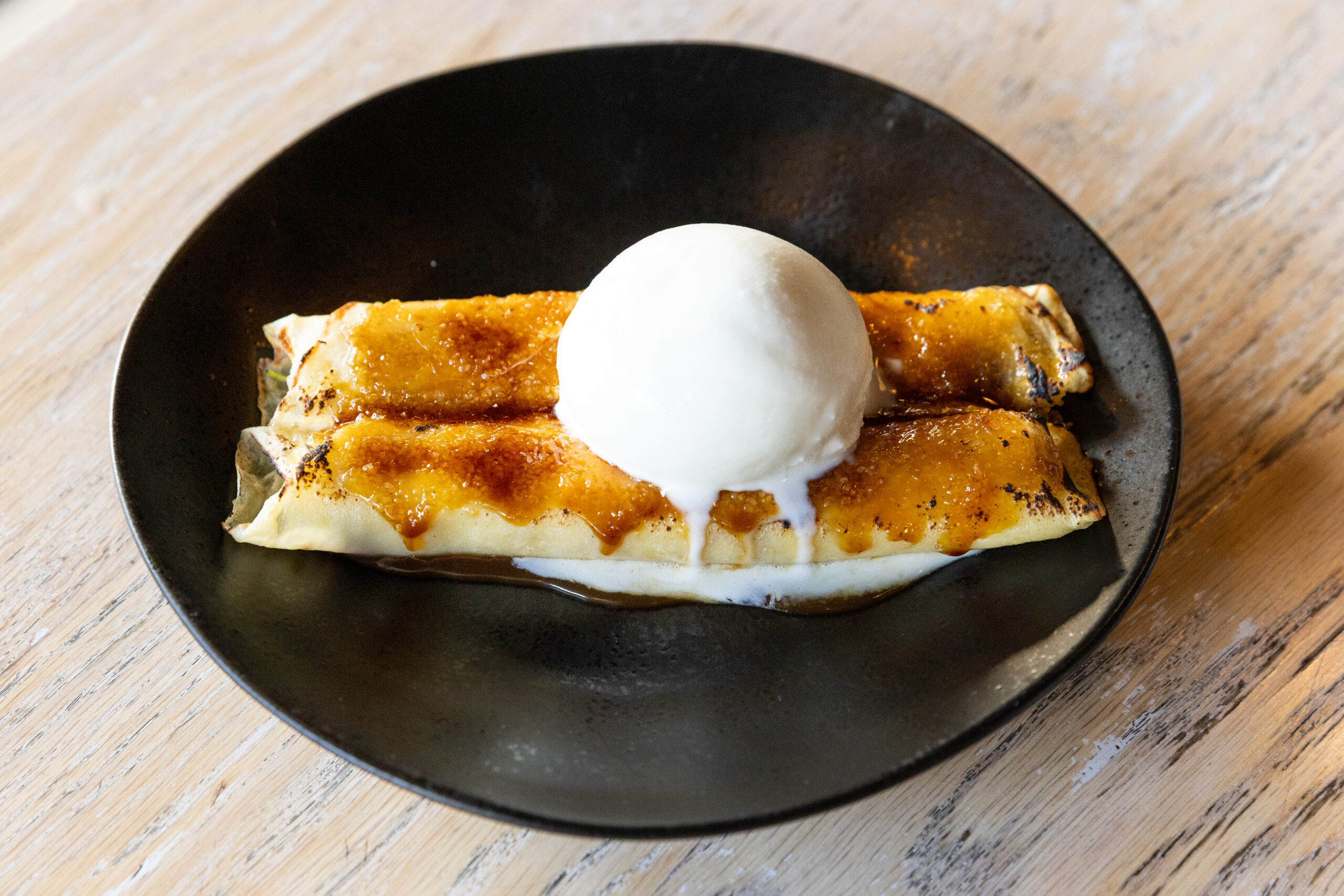 crepe crème brûlée with diplomat crème, berries, caramel and sweet milk ice cream