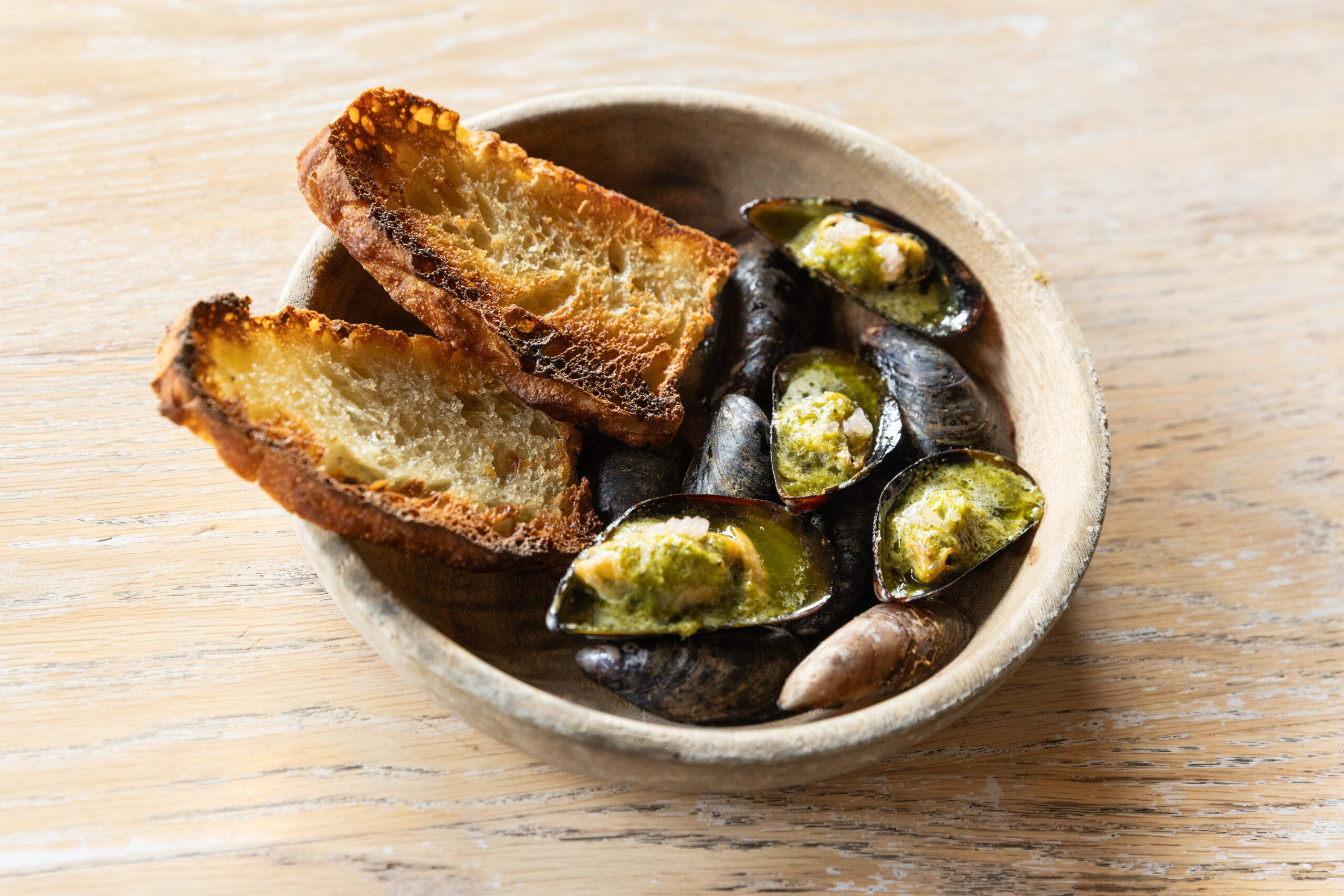 A photo of mussels on the half shell.