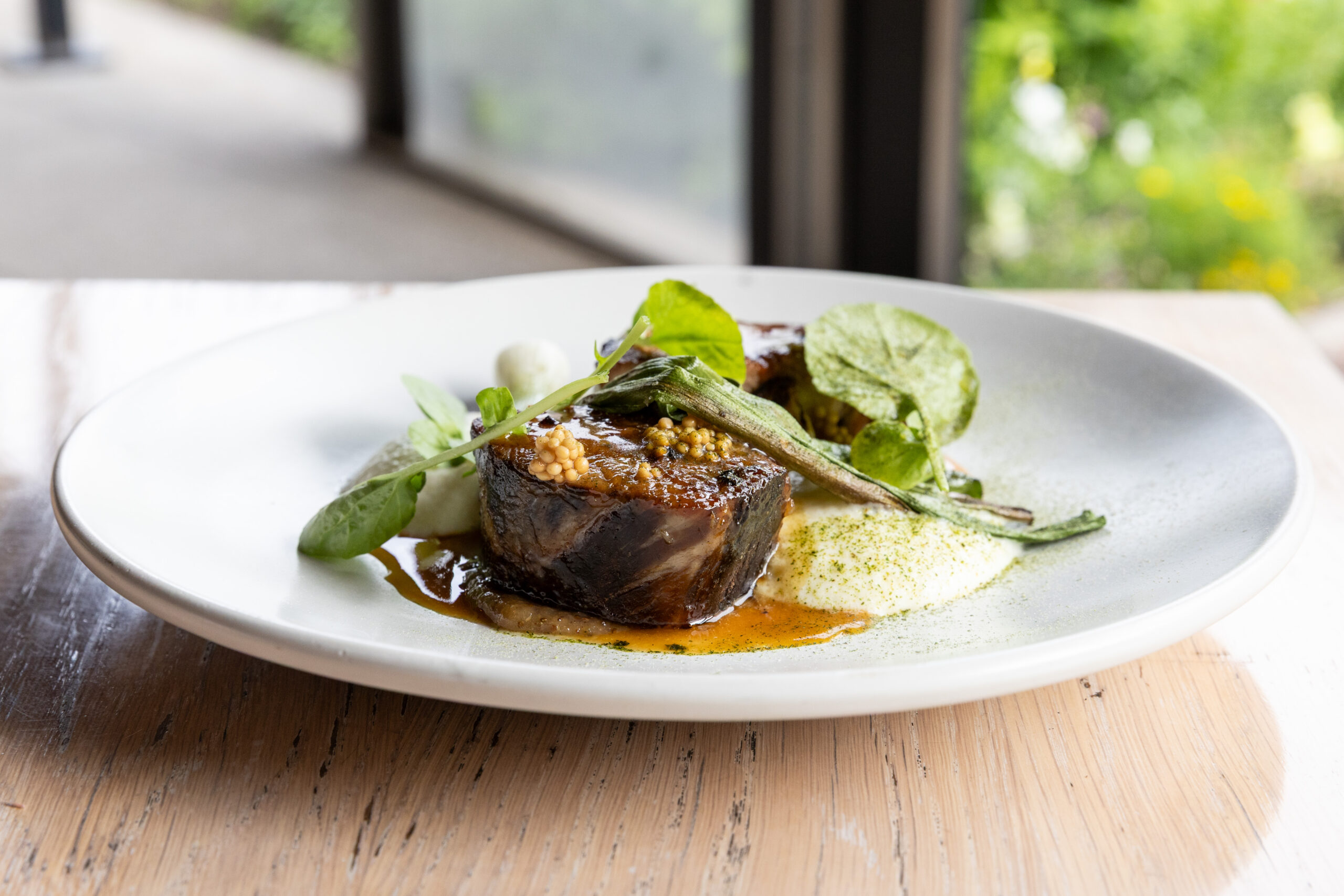 BBQ pork collar with buttermilk potatoes, green strawberry mostarda, onions and watercress 