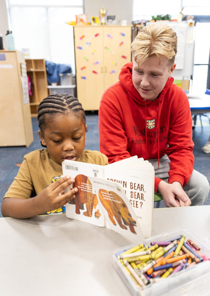 Mason Shaver reads with a kindergarten student at City Academy.